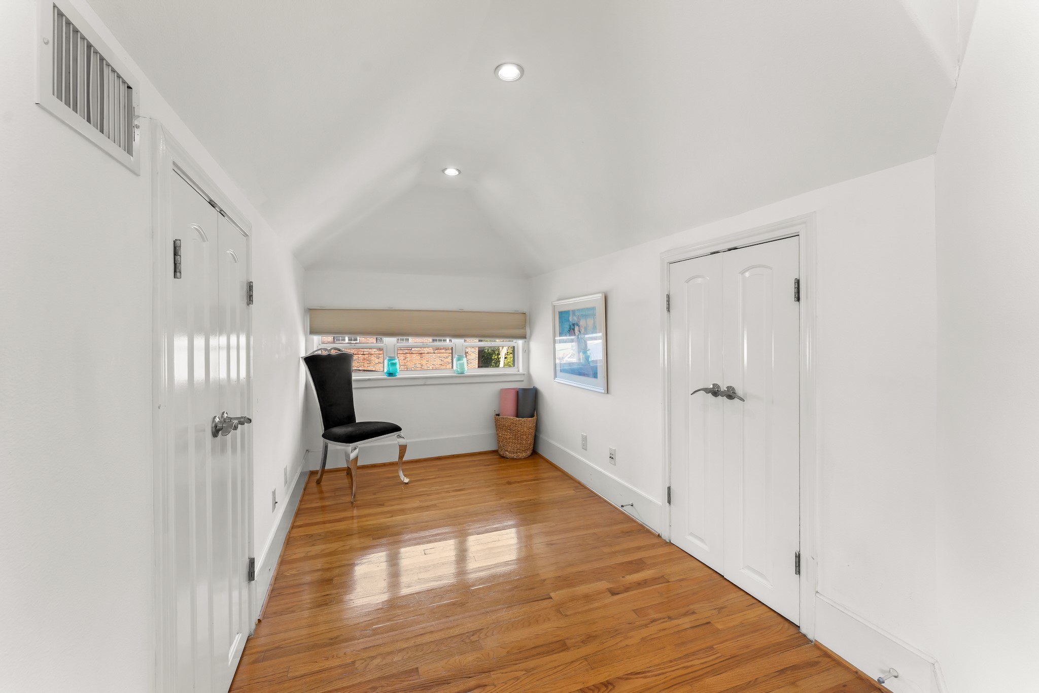 315 Fairview Street, Unit A Houston, TX 77006 - Photo 19 of 35 a view of a bedroom with wooden floor and windows