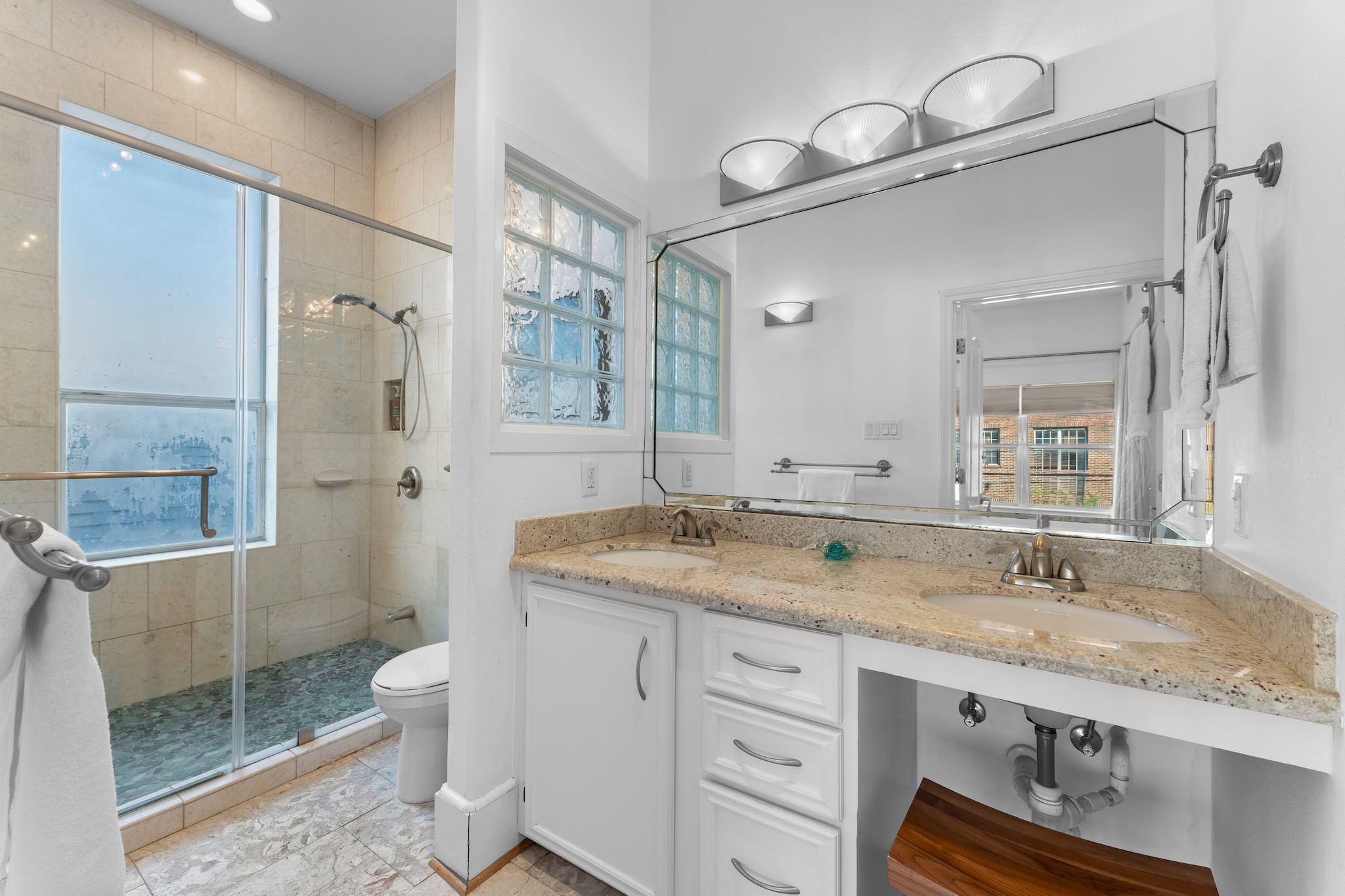 315 Fairview Street, Unit A Houston, TX 77006 - Photo 27 of 35 a bathroom with a granite countertop sink toilet and shower