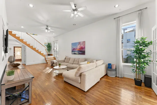 a living room with furniture and a potted plant