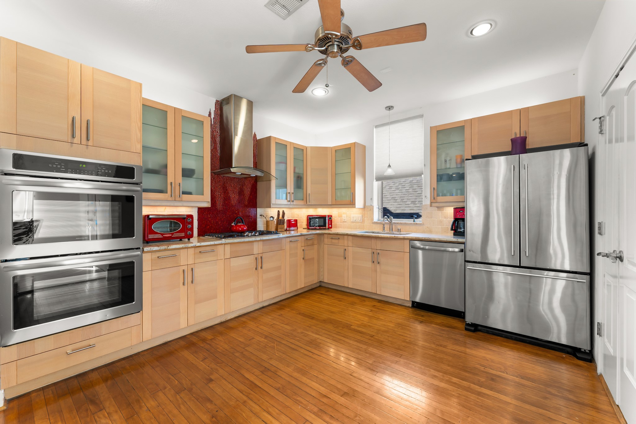 315 Fairview Street, Unit A Houston, TX 77006 - Photo 7 of 35 a kitchen with stainless steel appliances granite countertop a refrigerator a stove and a sink