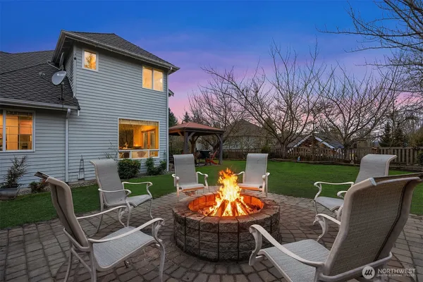 a view of a patio with chair and tables