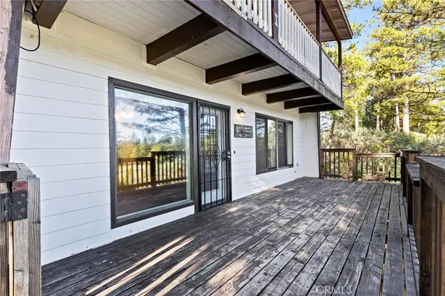 a view of a room with wooden floor and a ceiling fan