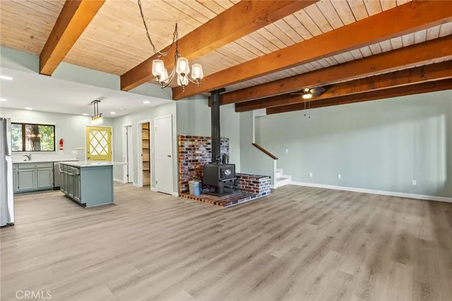 a view of a room with wooden floor and a window