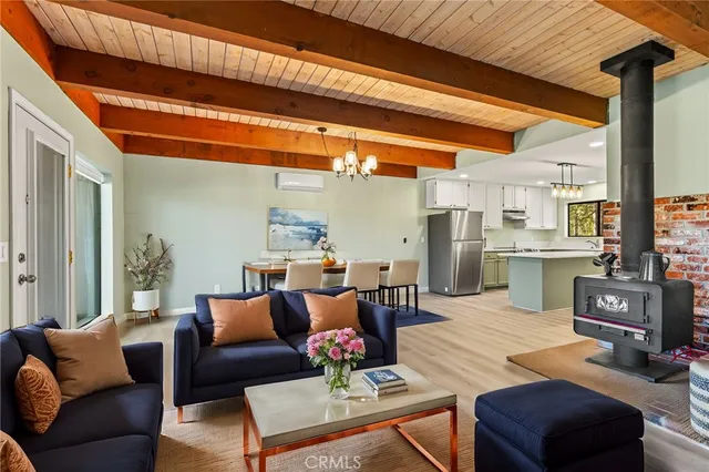 a view of kitchen with refrigerator stove and wooden floor
