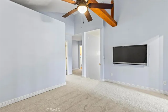 a bedroom with a bed and a television