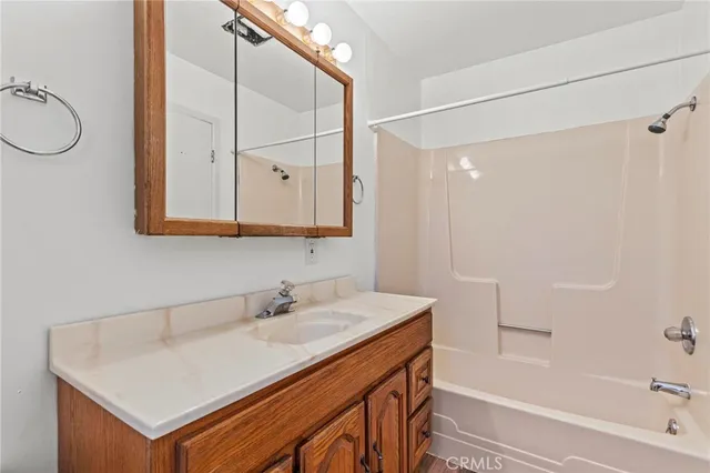 a view of a house with a tree in the yard