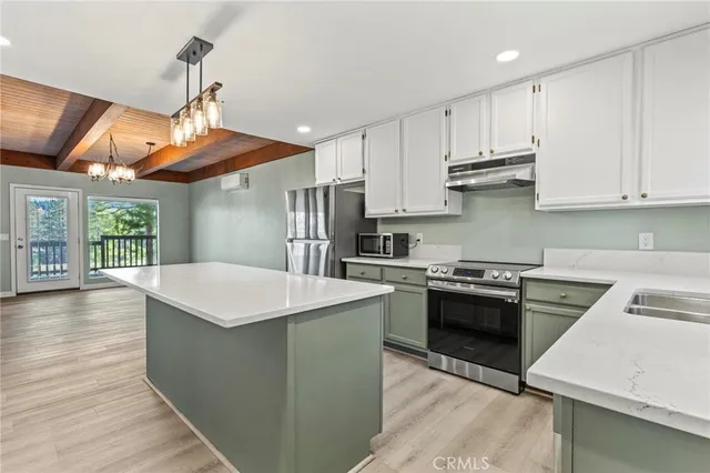 a view of a kitchen with a refrigerator and a sink