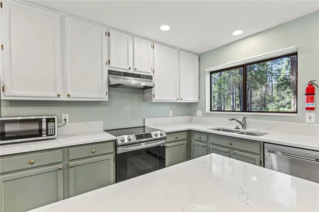 a kitchen with a sink stove and cabinets