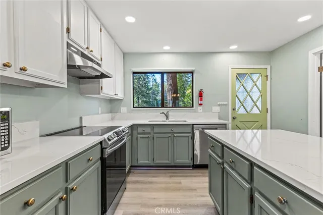 a kitchen with stainless steel appliances a refrigerator and a stove top oven