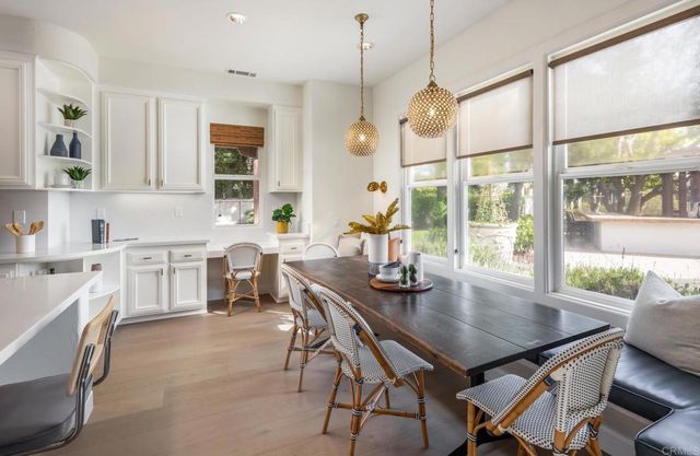 a view of a dining room and a table with chairs