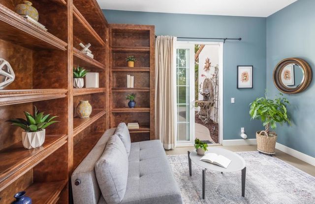 a dining room with furniture and potted plant