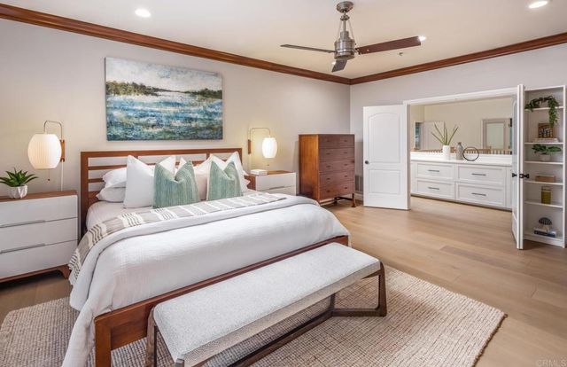 a bedroom with a bed a dresser and painting