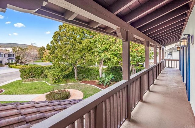 a view of a porch with furniture and a yard