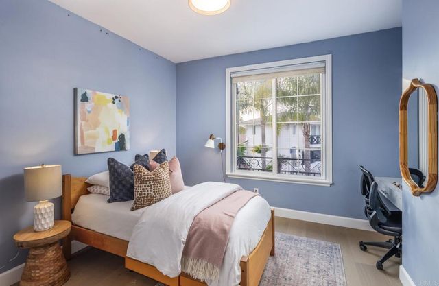 a bedroom with a bed a mirror and a window