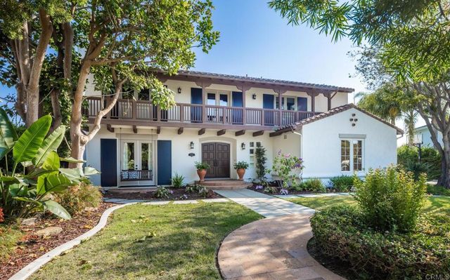a front view of a house with a yard and porch