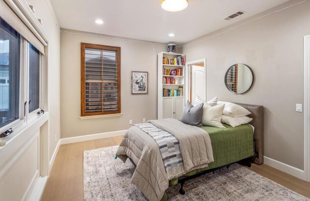 a bedroom with a large bed and a window