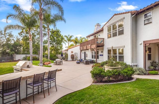 a view of a house with backyard sitting area and swimming pool