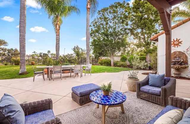 a view of a patio with couches and a fire pit