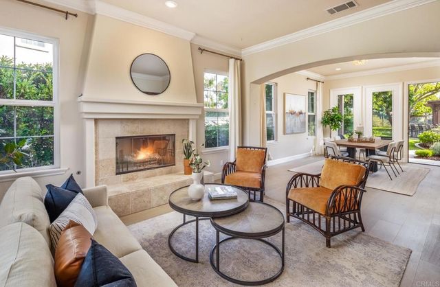 a living room with furniture a large window and a fireplace