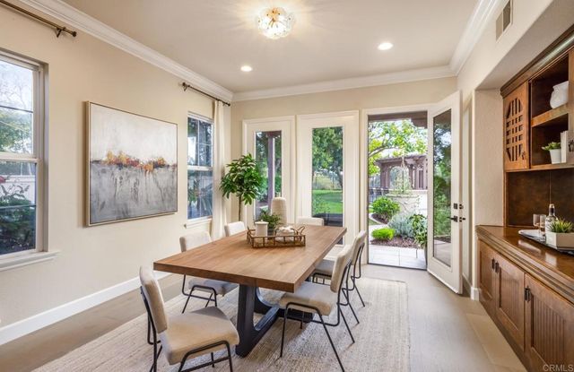a view of a dining room with furniture large window and wooden floor