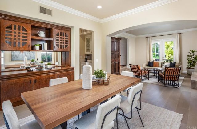 a dining room with furniture and wooden floor