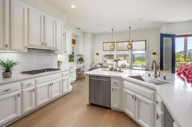 a kitchen with cabinets a sink and appliances