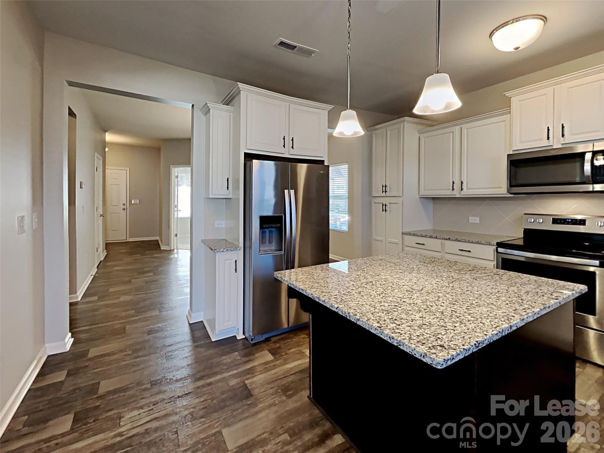 543 Contentment Drive Locust, NC 28097 - Photo 32 of 36 a kitchen with stainless steel appliances granite countertop a sink a stove and refrigerator