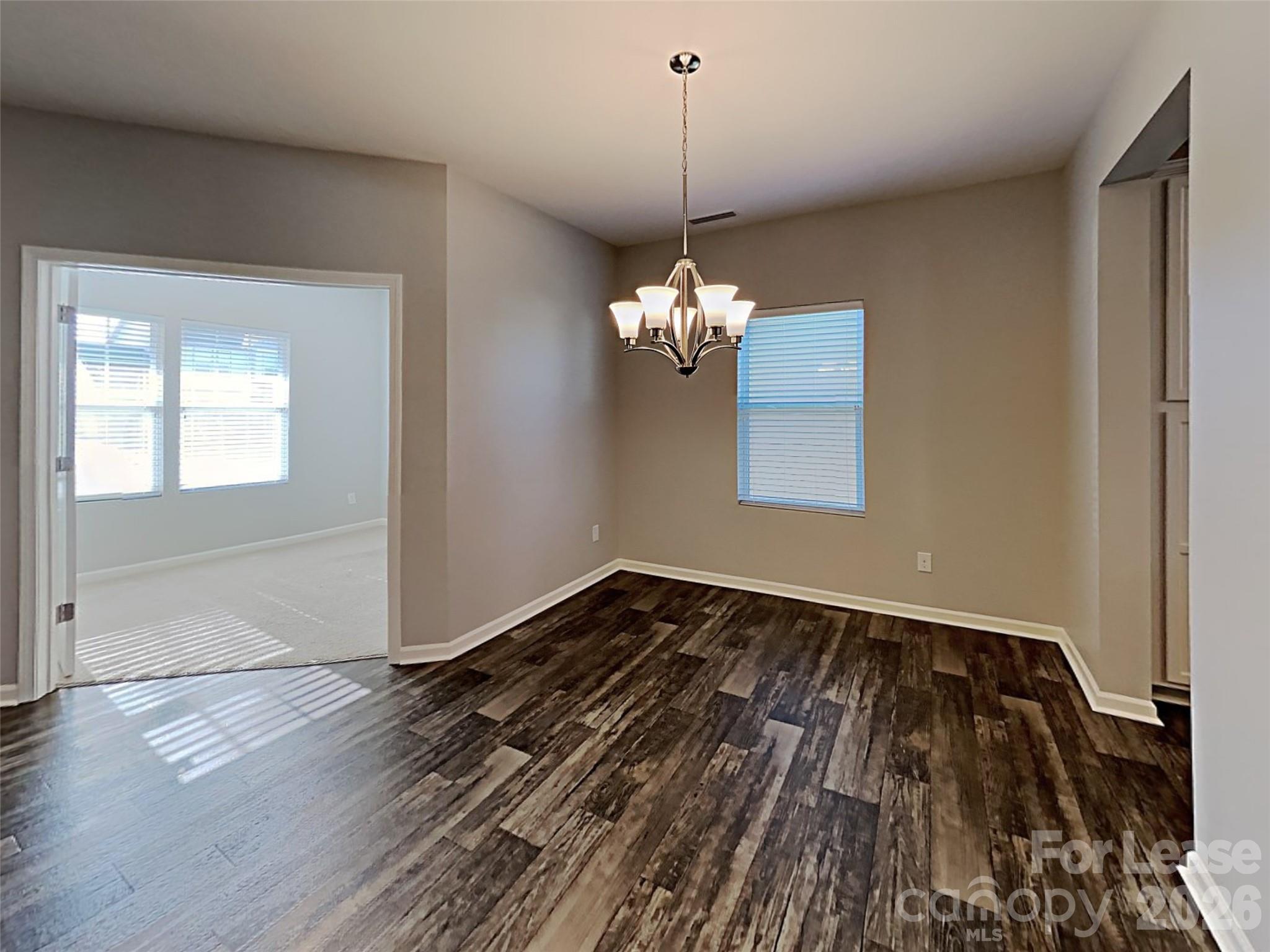 543 Contentment Drive Locust, NC 28097 - Photo 35 of 36 a view of a room with wooden floor chandelier and a window