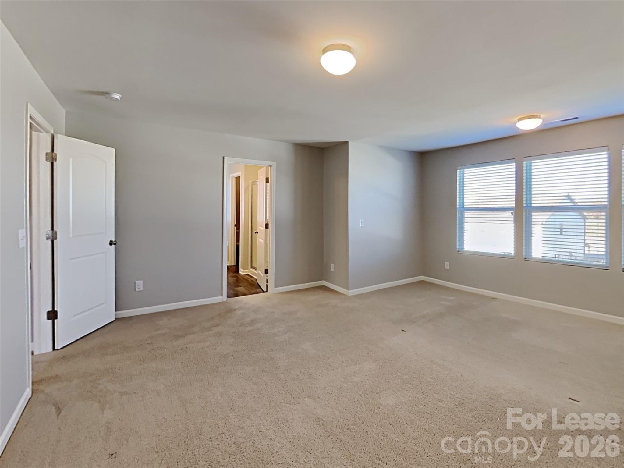 543 Contentment Drive Locust, NC 28097 - Photo 4 of 36 an empty room with windows and closet