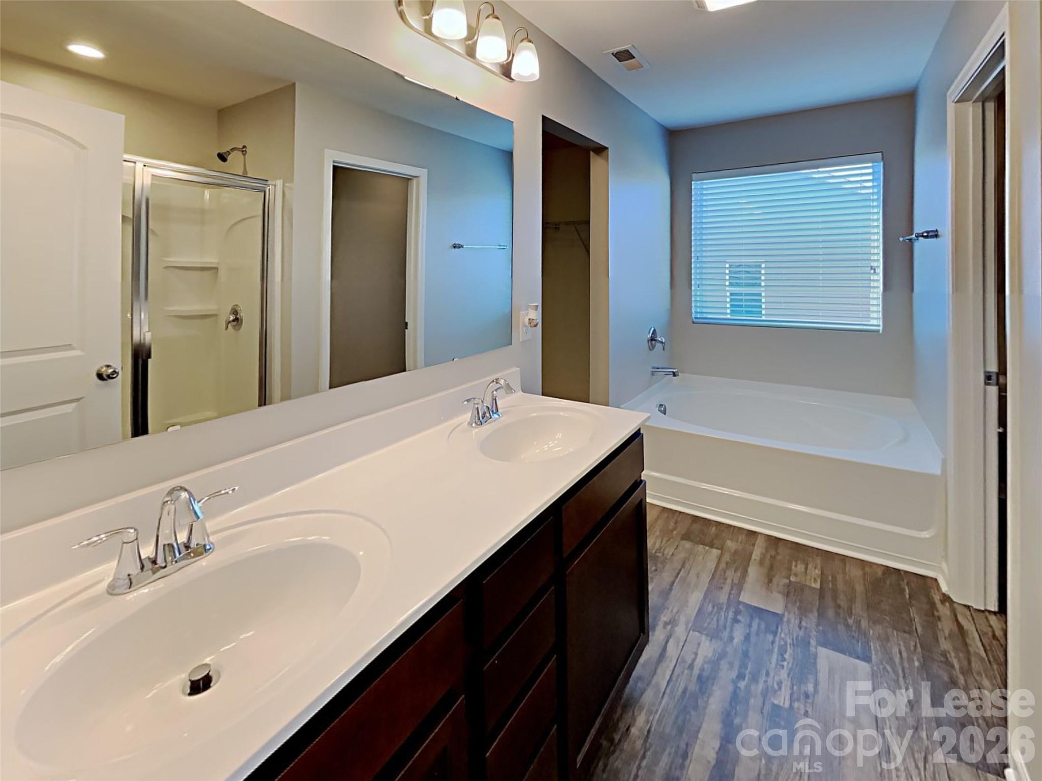 543 Contentment Drive Locust, NC 28097 - Photo 5 of 36 a bathroom with a double vanity sink a mirror and a bathtub