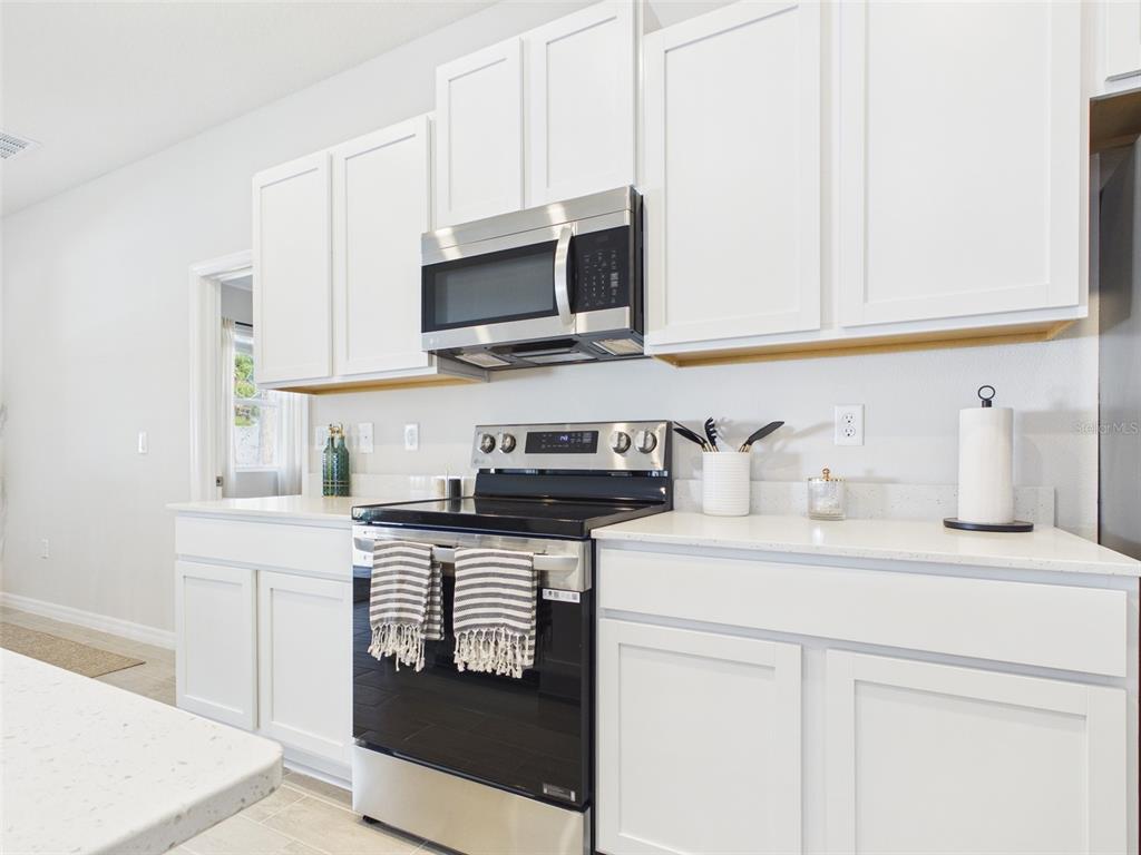 7348 Southwest 134th Street Ocala, FL 34473 - Photo 15 of 49 a kitchen with stainless steel appliances granite countertop a sink and a stove