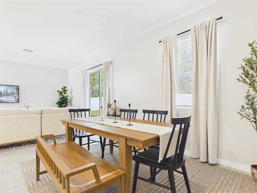 7348 Southwest 134th Street Ocala, FL 34473 - Photo 16 of 49 a view of a dining room with furniture and wooden floor