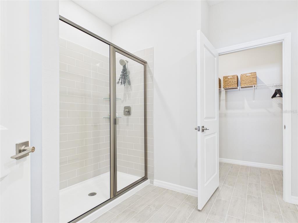 7348 Southwest 134th Street Ocala, FL 34473 - Photo 34 of 49 a bathroom with a shower and a glass door