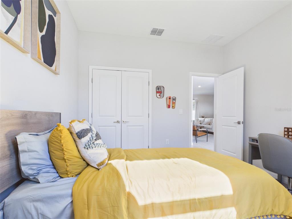 7348 Southwest 134th Street Ocala, FL 34473 - Photo 40 of 49 a bedroom with a bed and a chair