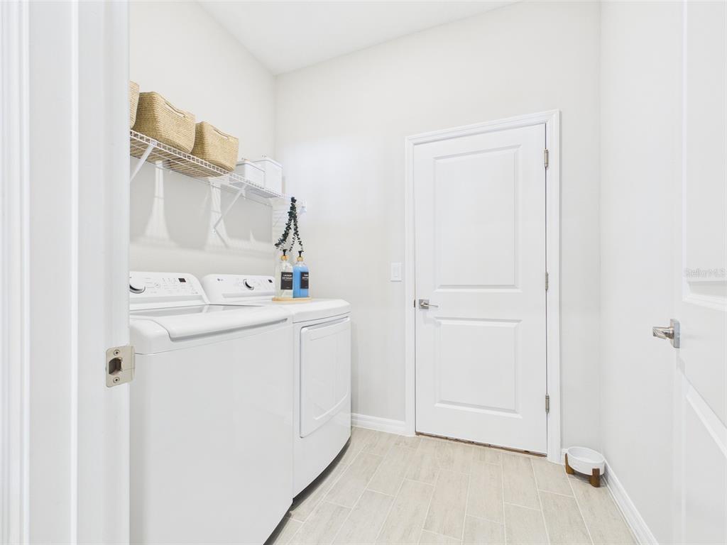 7348 Southwest 134th Street Ocala, FL 34473 - Photo 46 of 49 a utility room with cabinets washer and dryer