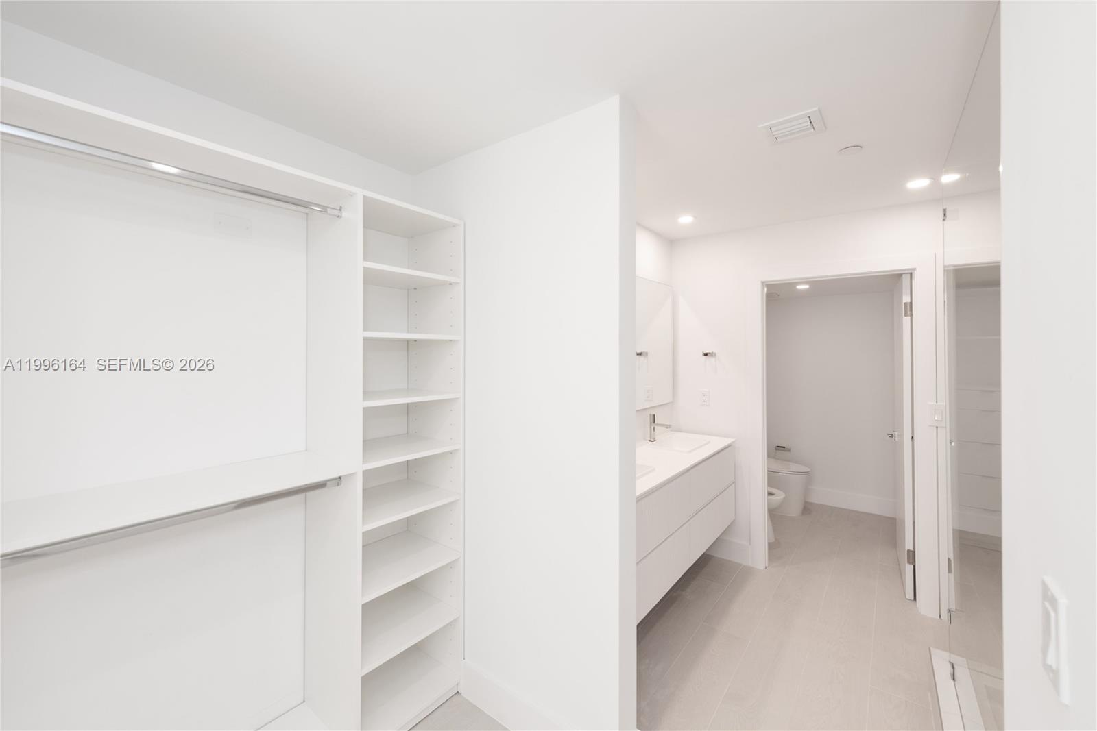151 Crandon Boulevard, Unit 241 Key Biscayne, FL 33149 - Photo 15 of 28 a bathroom with a bathtub and a walk in closet