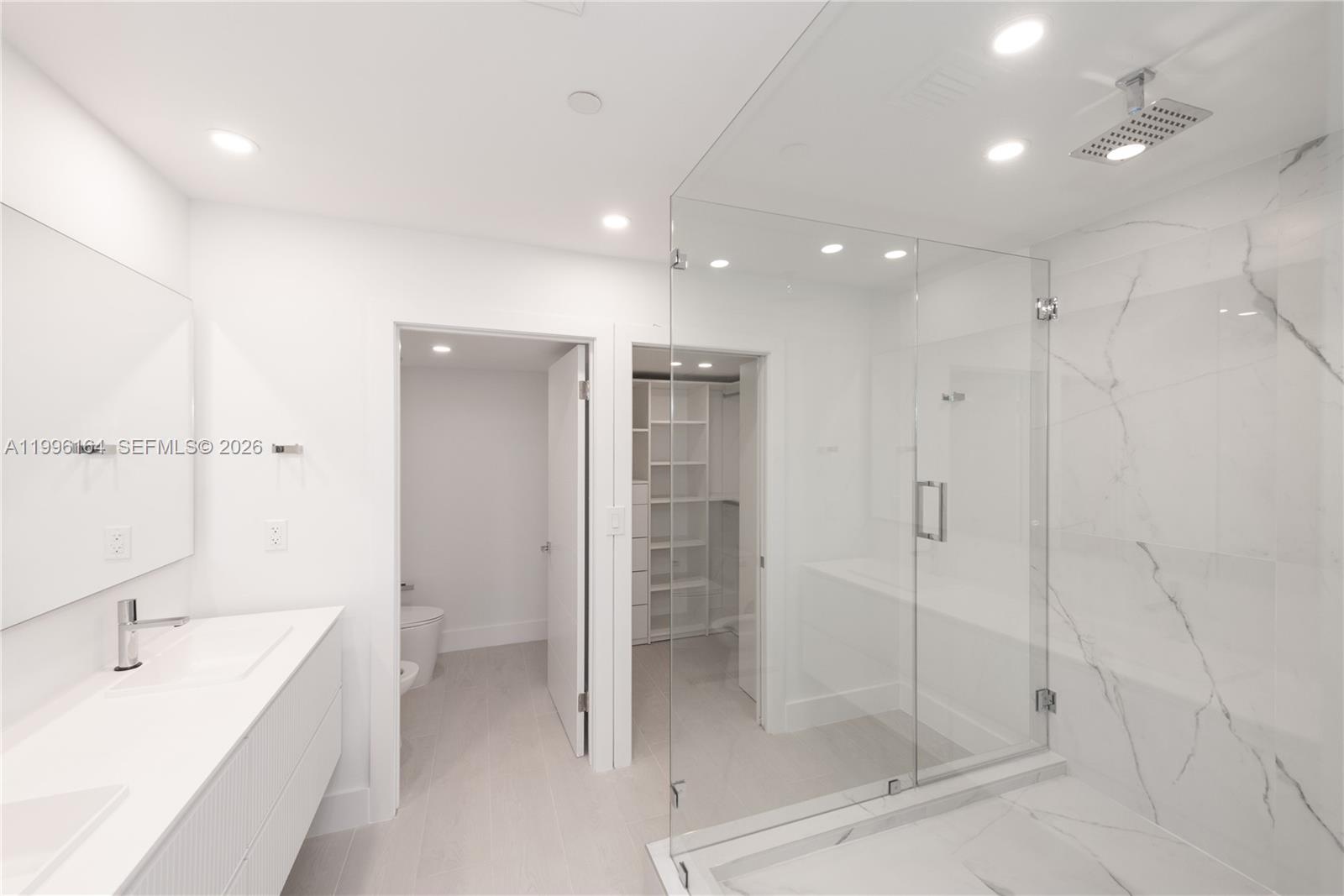 151 Crandon Boulevard, Unit 241 Key Biscayne, FL 33149 - Photo 16 of 28 a bathroom with a shower and a sink