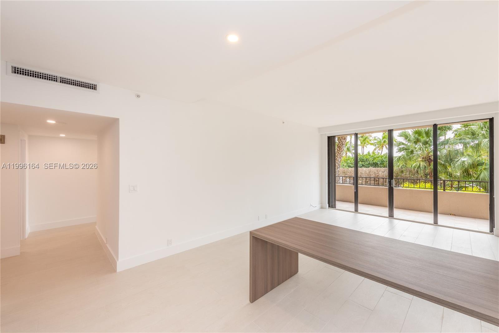 151 Crandon Boulevard, Unit 241 Key Biscayne, FL 33149 - Photo 6 of 28 wooden floor in an empty room with a window