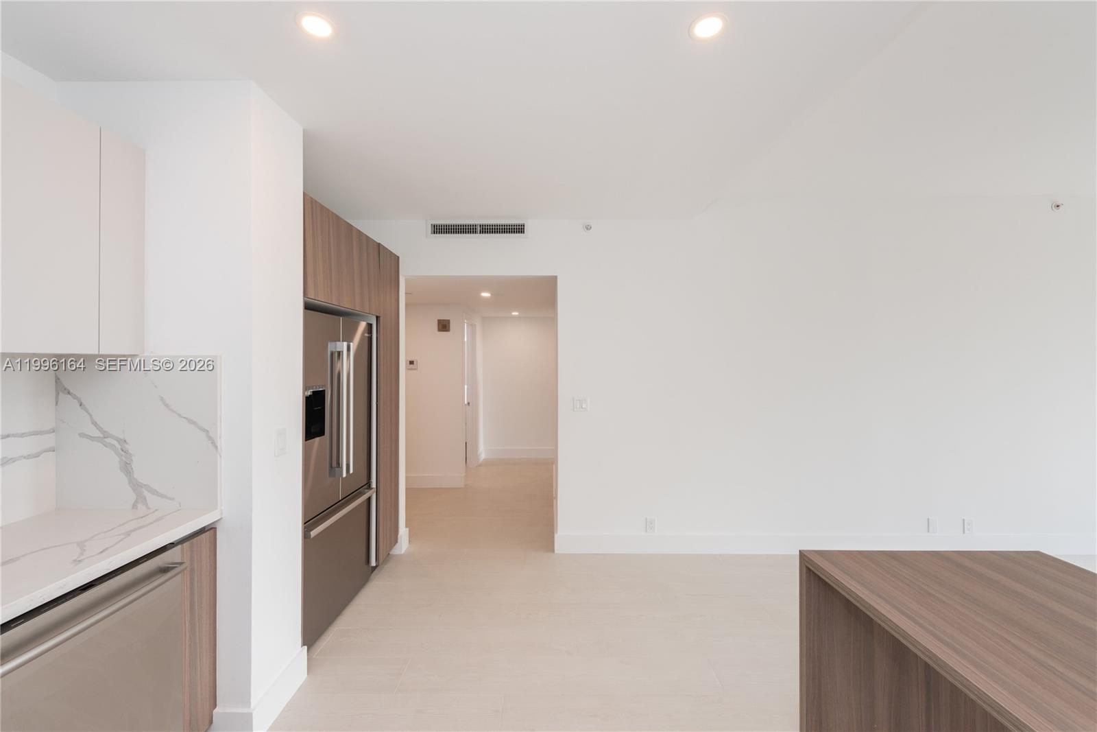 151 Crandon Boulevard, Unit 241 Key Biscayne, FL 33149 - Photo 8 of 28 a view of a kitchen from the hallway