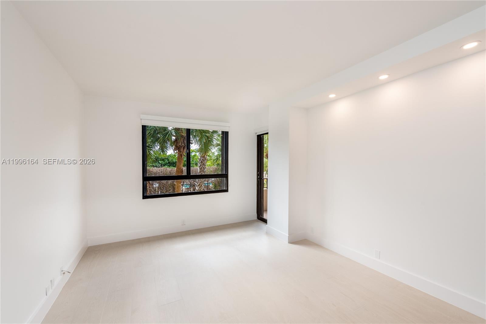 151 Crandon Boulevard, Unit 241 Key Biscayne, FL 33149 - Photo 10 of 28 a view of a big room with windows and chandelier fan