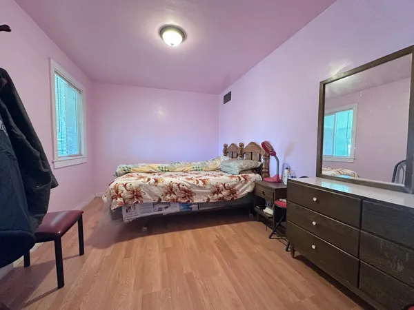 a bedroom with a bed and a dresser