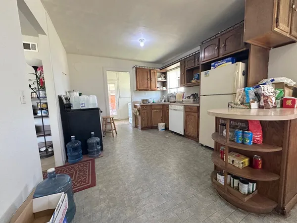 a kitchen with refrigerator and cabinets