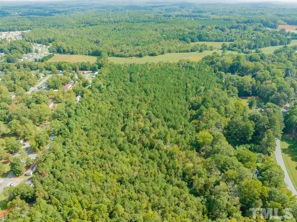 a view of a field of grass and trees