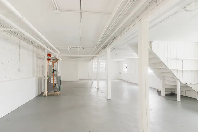 a view of a livingroom with stairs and furniture