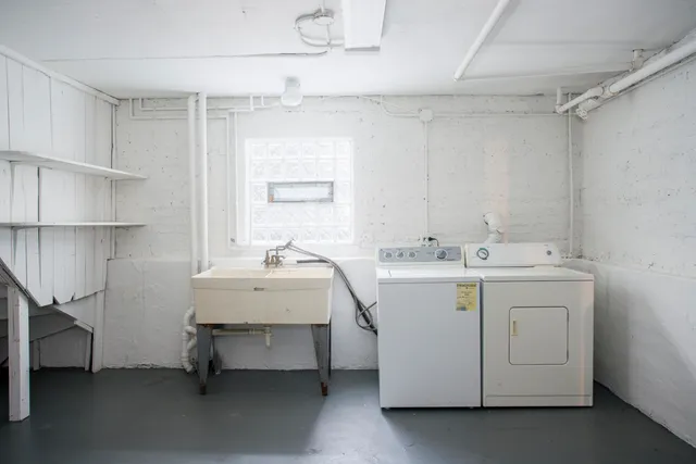 a utility room with cabinets and washer dryer
