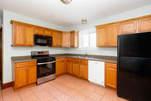 a kitchen with stainless steel appliances granite countertop a stove top oven a sink dishwasher and granite countertops