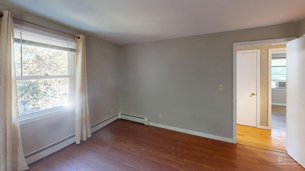 18 Cranston Circle Woburn, MA 01801 - Photo 15 of 19 an empty room with wooden floor and windows