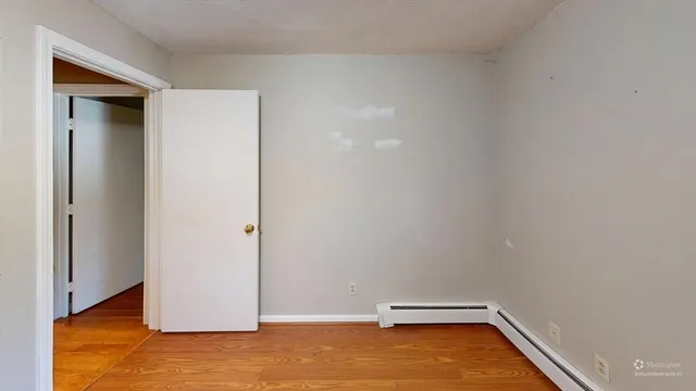 a view of a room with wooden floor