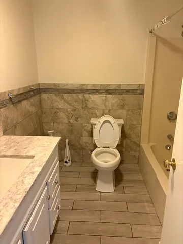 a bathroom with a toilet sink and vanity