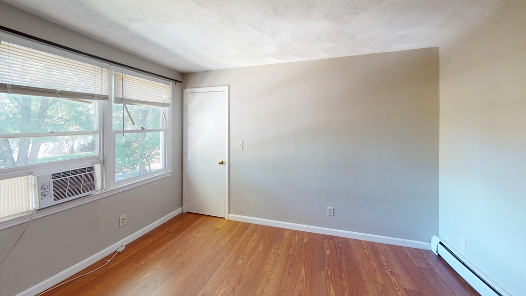 18 Cranston Circle Woburn, MA 01801 - Photo 6 of 19 an empty room with wooden floor and windows